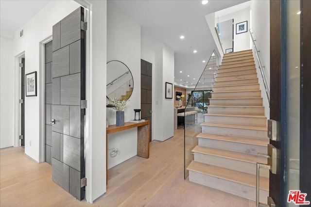 stairs featuring wood-type flooring