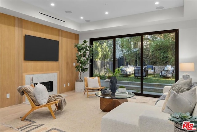 interior space featuring access to outside, a fireplace, and wood walls