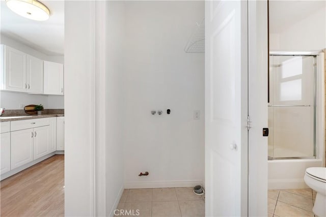 washroom with light tile patterned floors