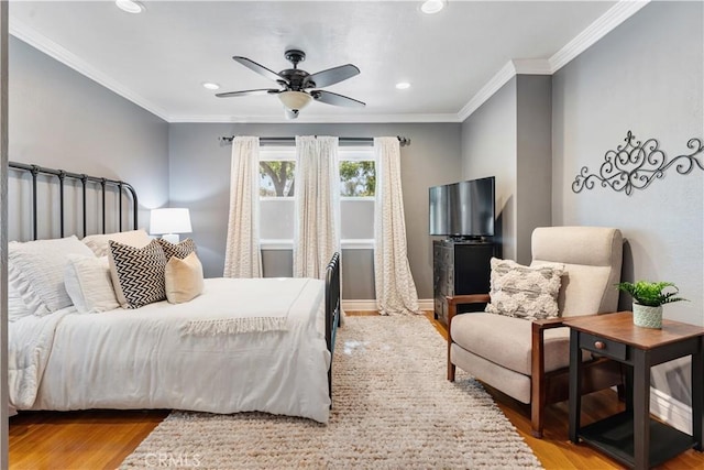 bedroom with ceiling fan, light wood-type flooring, and crown molding