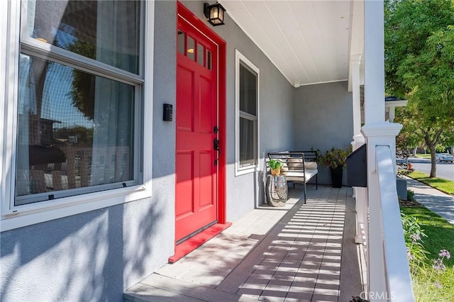 view of exterior entry with a porch