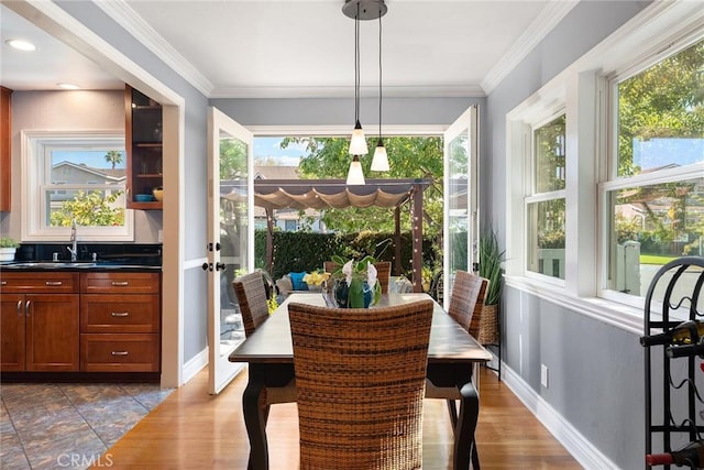 dining space with sink and ornamental molding