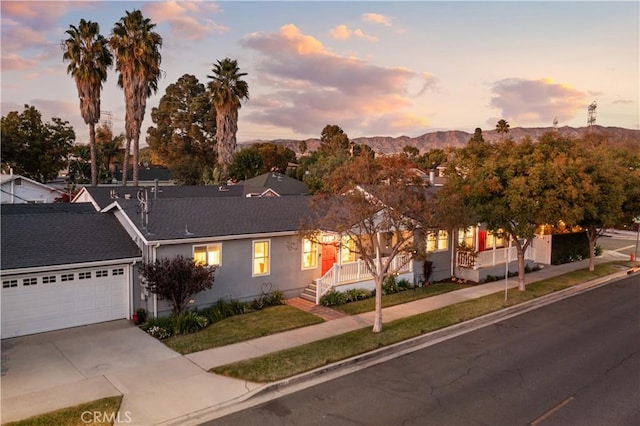 view of front of property with a mountain view and a garage