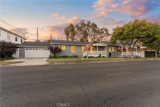 single story home with covered porch and a garage