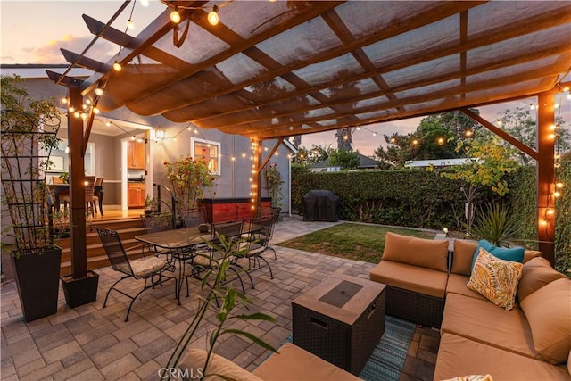 patio terrace at dusk with an outdoor living space and a pergola