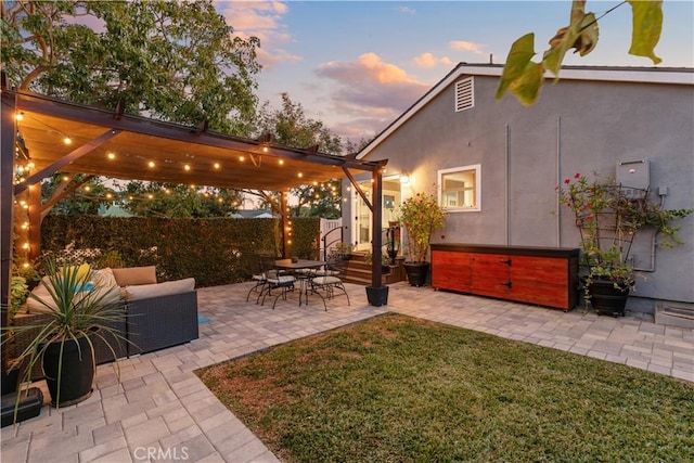 yard at dusk with a pergola and a patio area