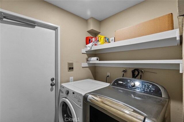 clothes washing area featuring washing machine and dryer