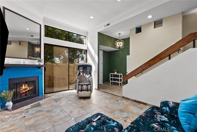 living room featuring crown molding and a tiled fireplace