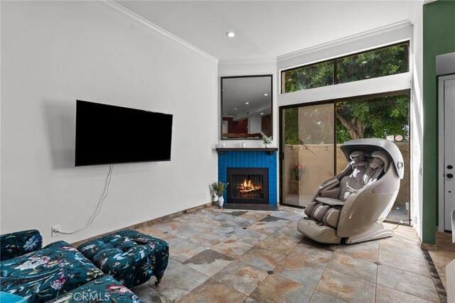 living room with ornamental molding and a fireplace