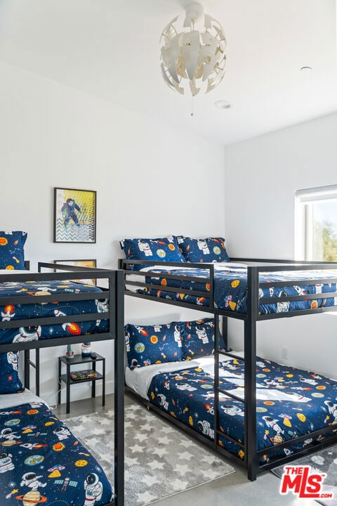 bedroom featuring concrete floors