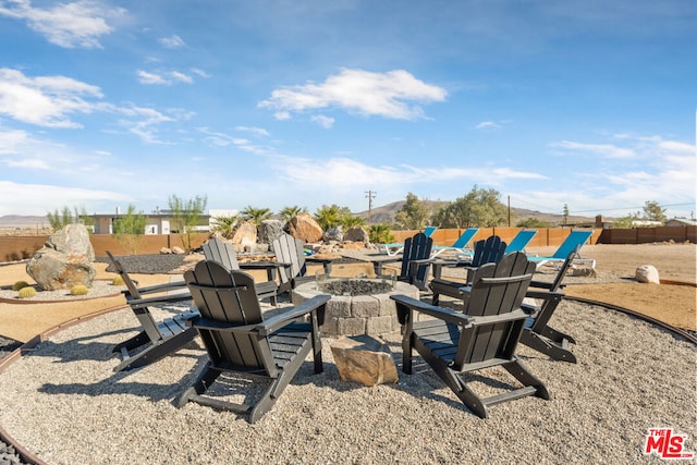 view of yard featuring an outdoor fire pit and a patio area