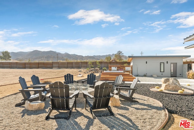 view of patio featuring a mountain view and a fire pit