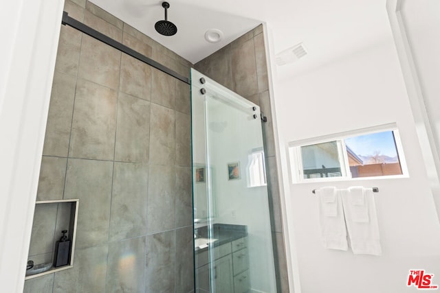 bathroom featuring a shower with shower door