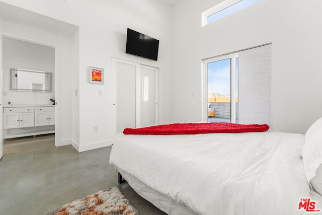 bedroom featuring multiple windows and ensuite bath