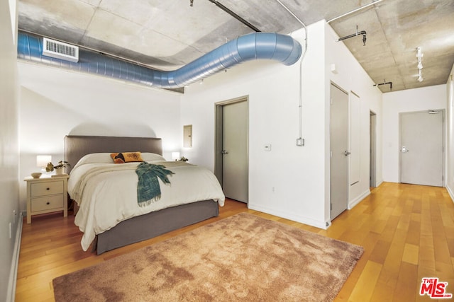 bedroom with hardwood / wood-style flooring