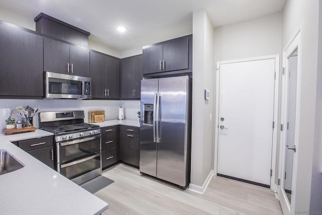 kitchen with stainless steel appliances and light hardwood / wood-style floors