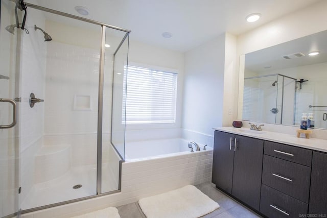 bathroom with tile patterned floors, vanity, and independent shower and bath