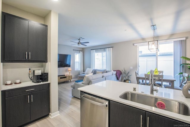 kitchen with ceiling fan, dishwasher, sink, light hardwood / wood-style floors, and pendant lighting