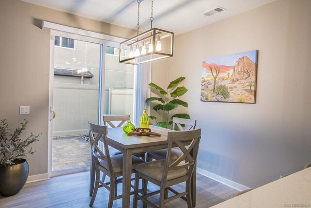 dining space with dark hardwood / wood-style flooring