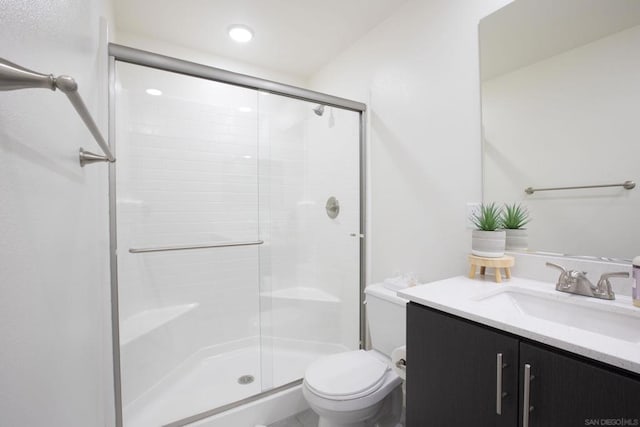 bathroom with vanity, toilet, and walk in shower