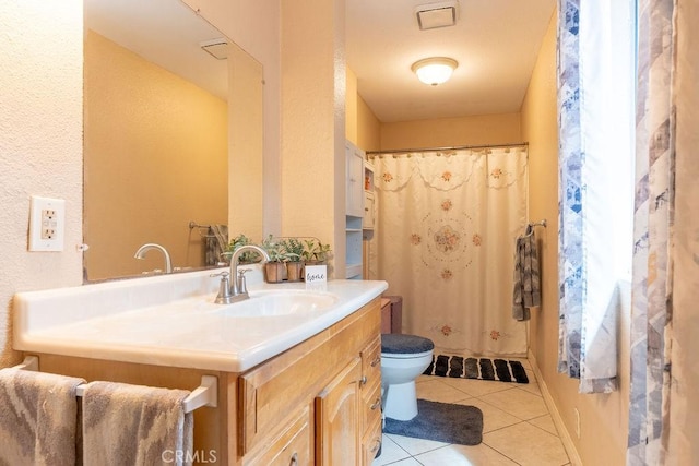 bathroom featuring tile patterned floors, vanity, and toilet