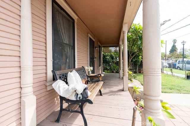 wooden terrace with a porch