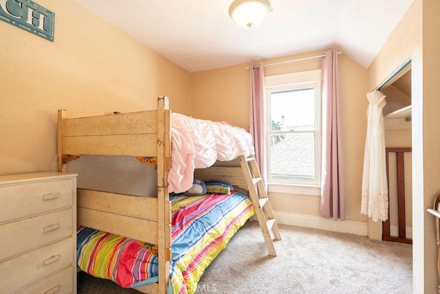 bedroom featuring carpet flooring and vaulted ceiling