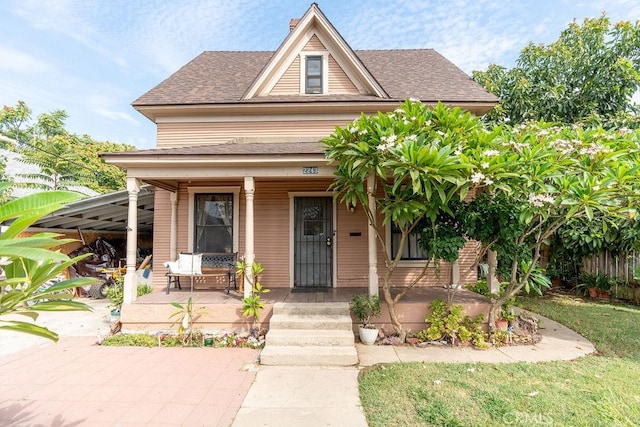 view of front of house with covered porch and a carport