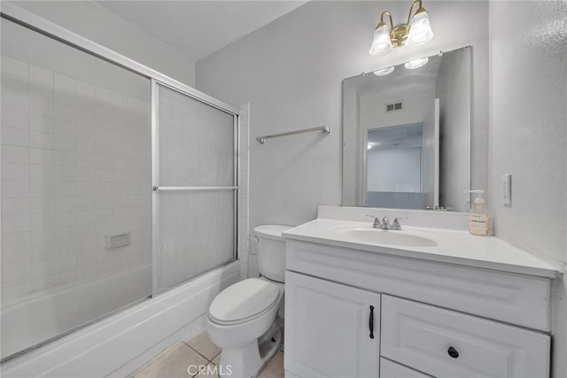 full bathroom with toilet, enclosed tub / shower combo, vanity, and tile patterned floors