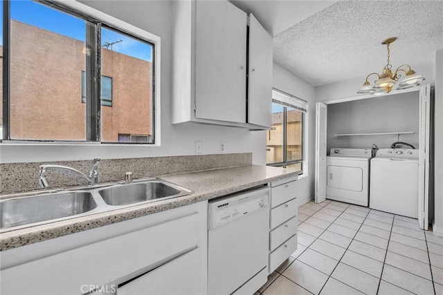 kitchen with dishwasher, sink, white cabinetry, hanging light fixtures, and light tile patterned floors