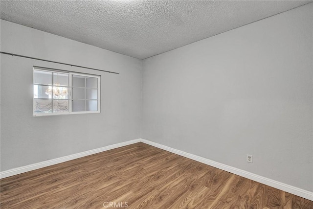 spare room with wood-type flooring and a textured ceiling