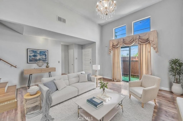 living room with a chandelier and wood-type flooring