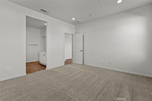 unfurnished bedroom featuring carpet and ensuite bathroom