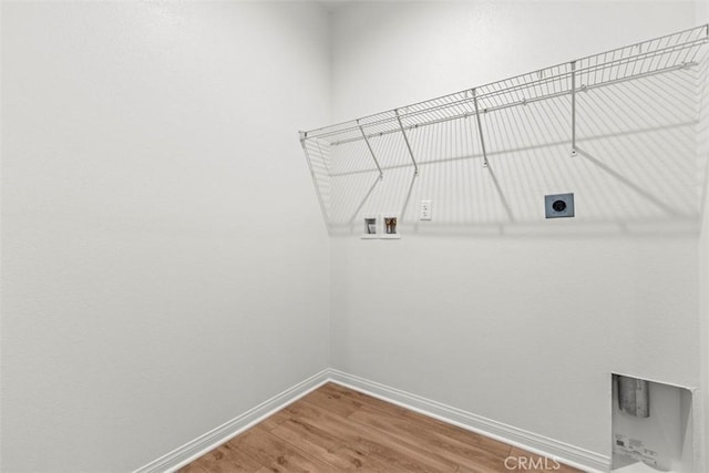 washroom featuring hookup for an electric dryer, wood-type flooring, and hookup for a washing machine