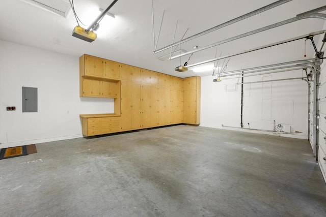 garage with a garage door opener and electric panel