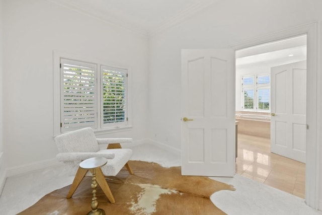 living area featuring crown molding and light tile patterned floors