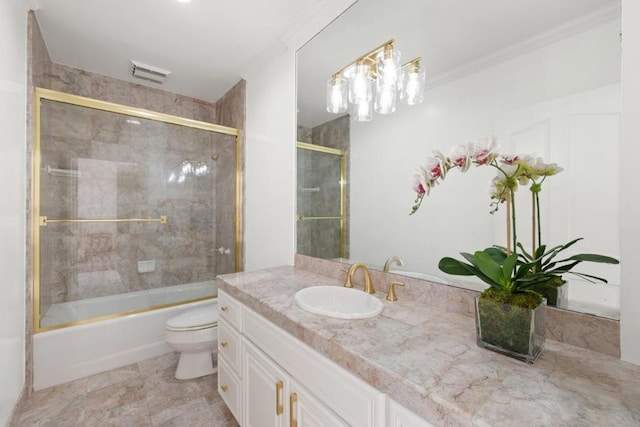 full bathroom featuring vanity, combined bath / shower with glass door, and toilet