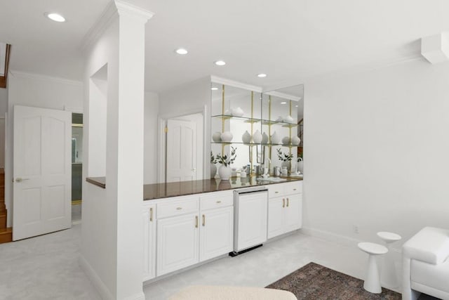 bar with white cabinetry, crown molding, sink, and ornate columns