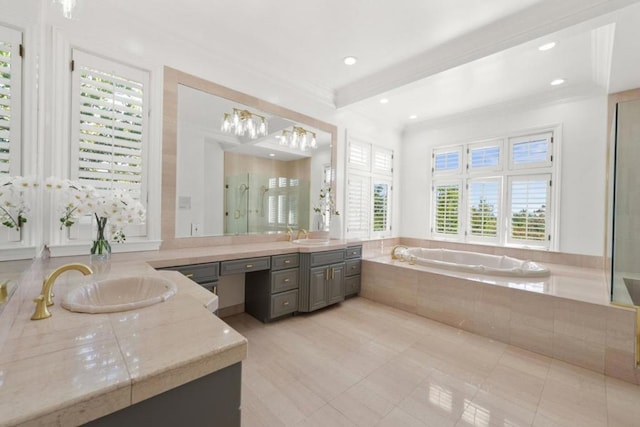 bathroom featuring vanity, tiled tub, crown molding, and tile patterned flooring