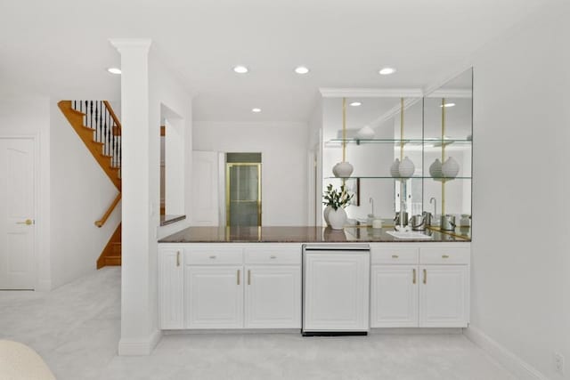 bar featuring crown molding, sink, light carpet, and white cabinets