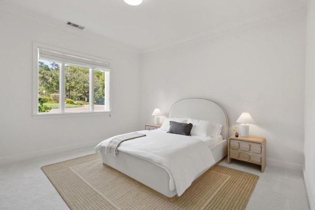 bedroom featuring ornamental molding and carpet