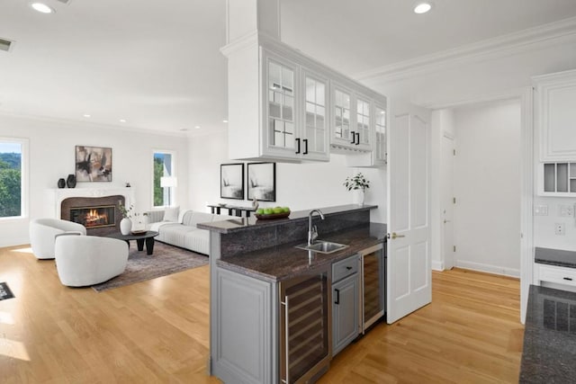 bar featuring crown molding, sink, wine cooler, and white cabinets