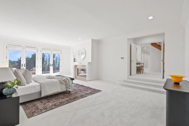 carpeted bedroom with crown molding, french doors, and access to outside