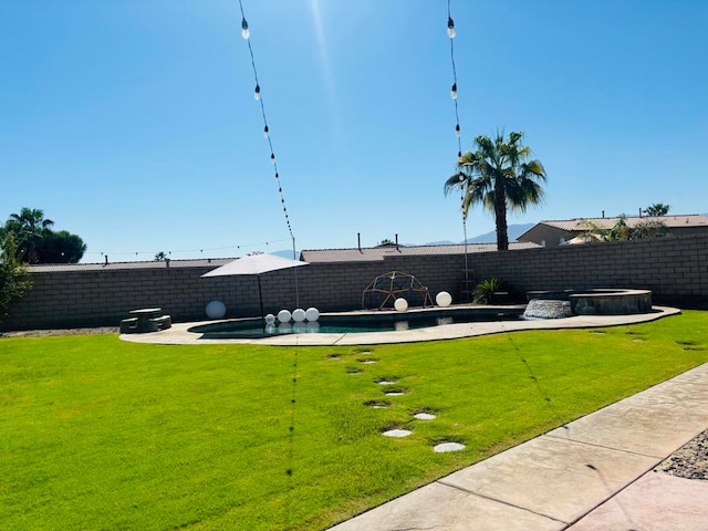 view of yard with a fenced in pool