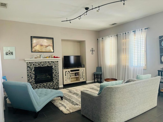 living room with a fireplace and rail lighting