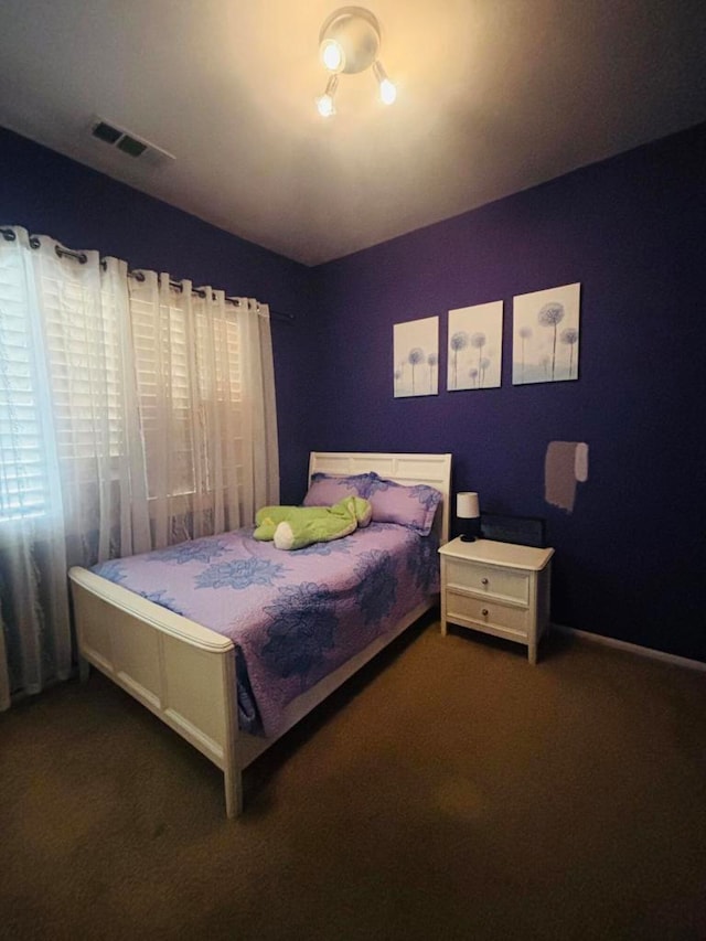 bedroom featuring dark colored carpet