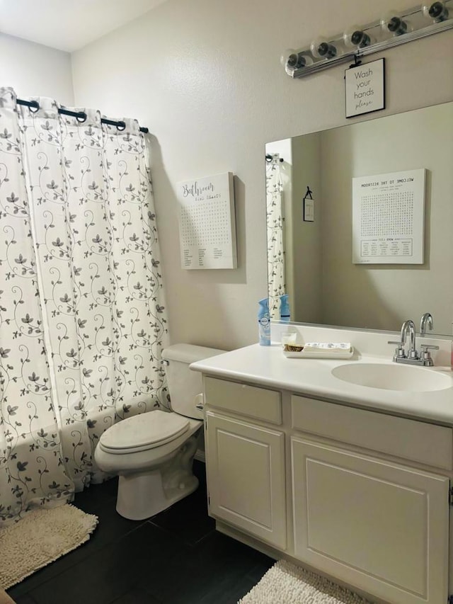 bathroom featuring tile patterned floors, vanity, and toilet