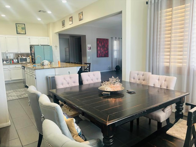 dining area featuring tile patterned floors, sink, and a wealth of natural light