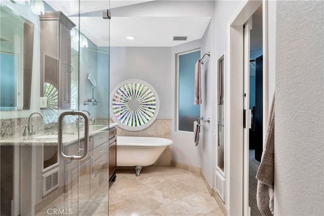 bathroom with vanity and separate shower and tub