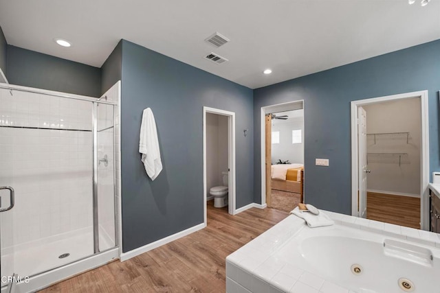 full bathroom with sink, hardwood / wood-style flooring, ceiling fan, toilet, and independent shower and bath